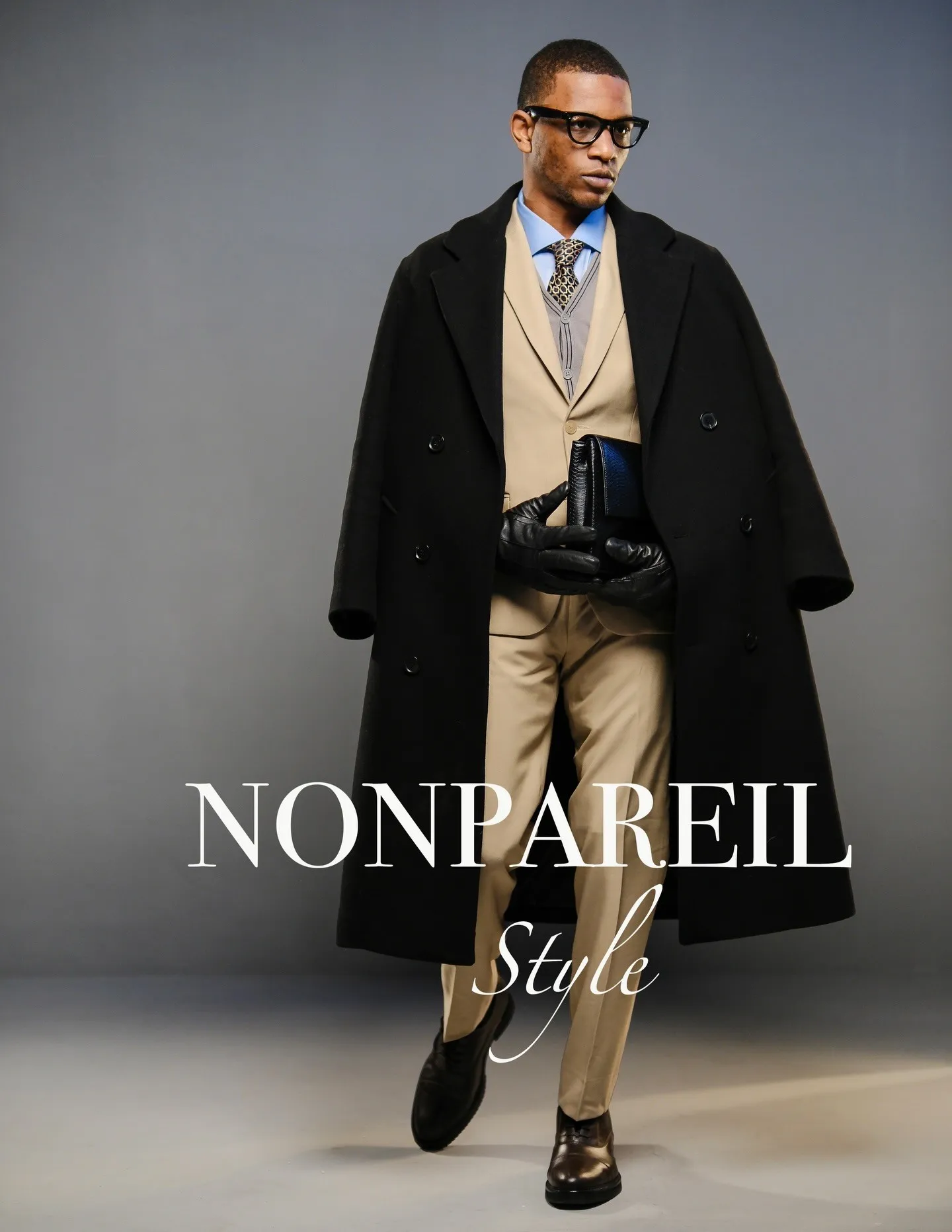 Travon Ridley-Evans in a black coat over a camel suit